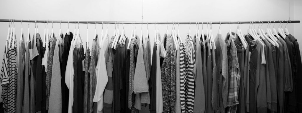 Minimalist black and white clothing display in a stylish boutique setting.